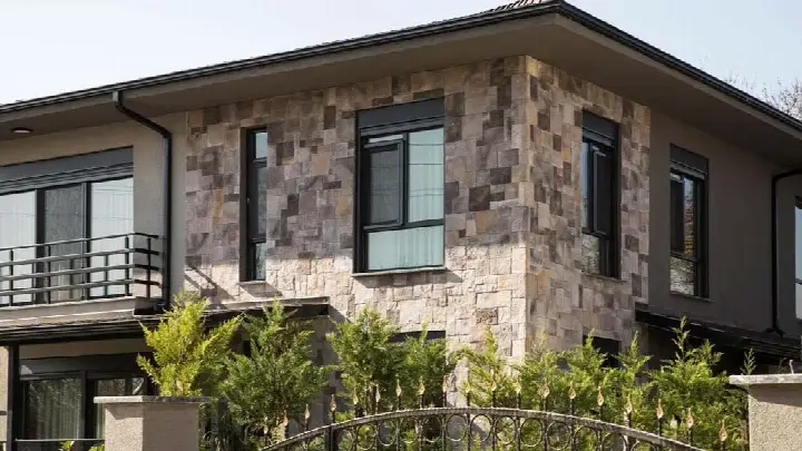 İki katlı evin cephesinde bej-gri karışık kültür taşı
